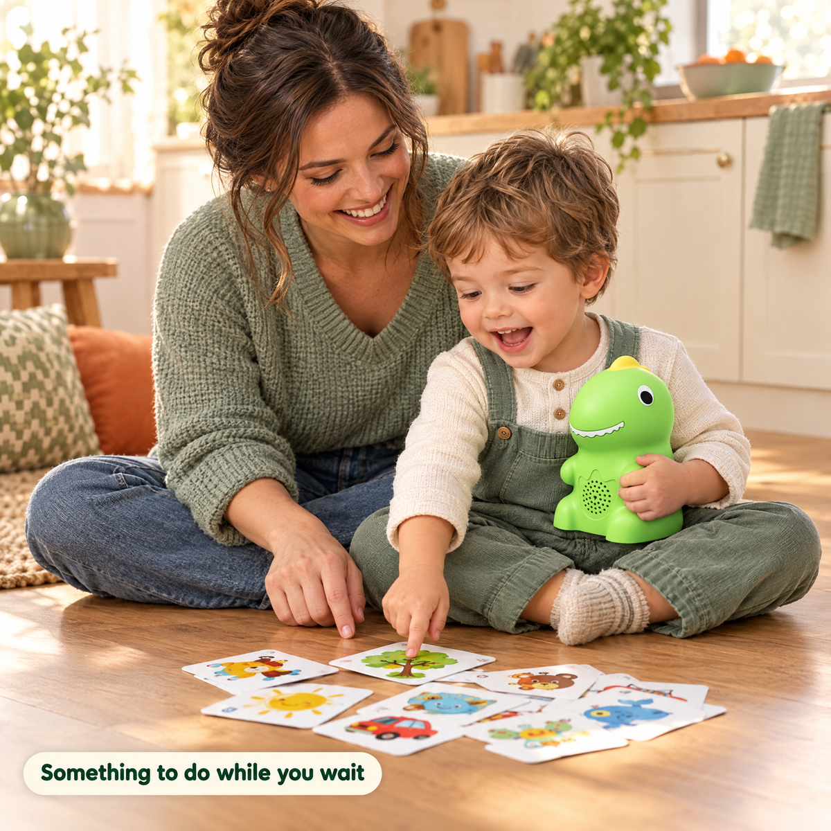 Toddler pointing at a picture card with the dino next to his mom