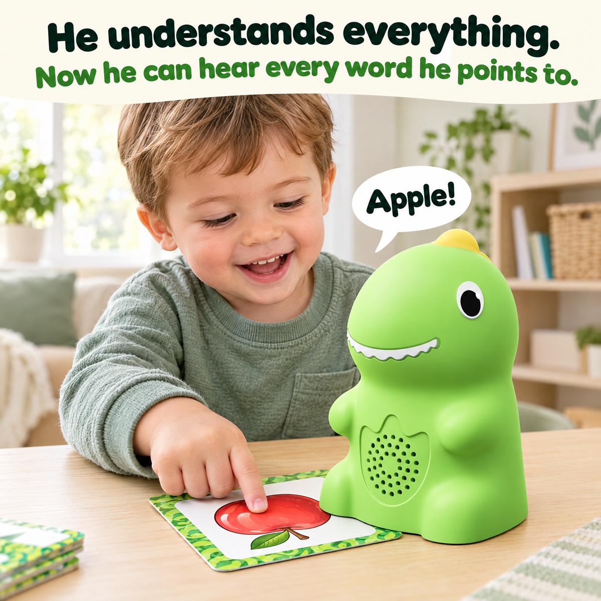 Toddler pointing at an apple card next to the Talking Dino